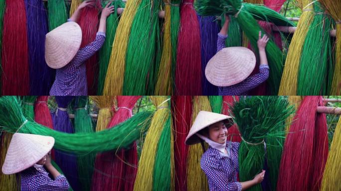 越南女工匠在越南东塔丁延老村干燥传统越南垫子的背面场景，传统艺术家概念