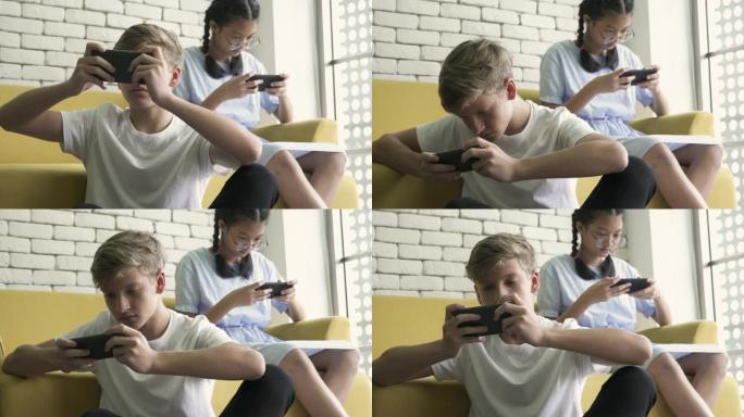 两个朋友忙着玩手机视频游戏