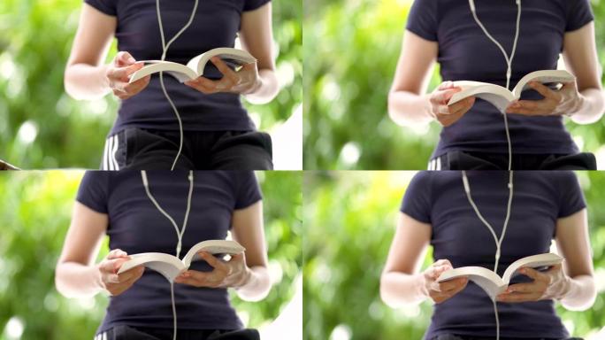 女人看书和用耳机听音乐的手持镜头
