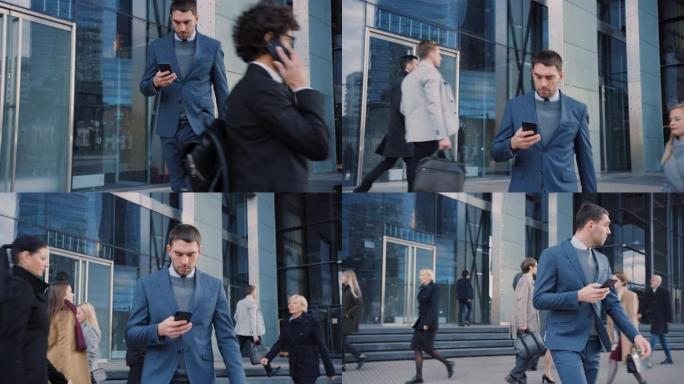 穿着西装的高加索商人正在市中心的一条街道上使用智能手机。其他办公室人员走过。他很自信，看起来很成功。