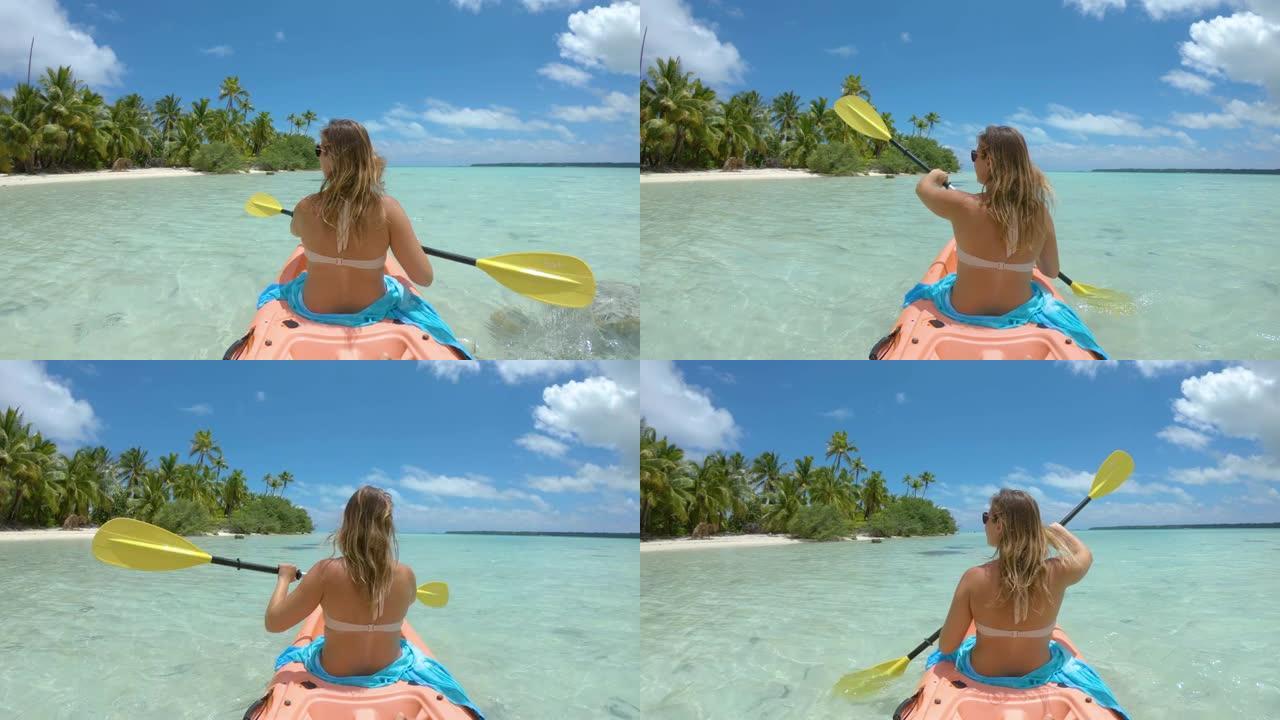 慢动作: 旅行者女孩划着皮划艇驶向令人惊叹的白色沙滩海岸。