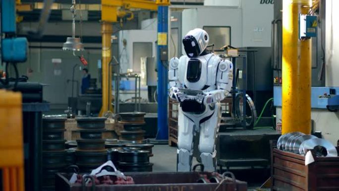 仿生机器人正在工厂单位操作平板电脑