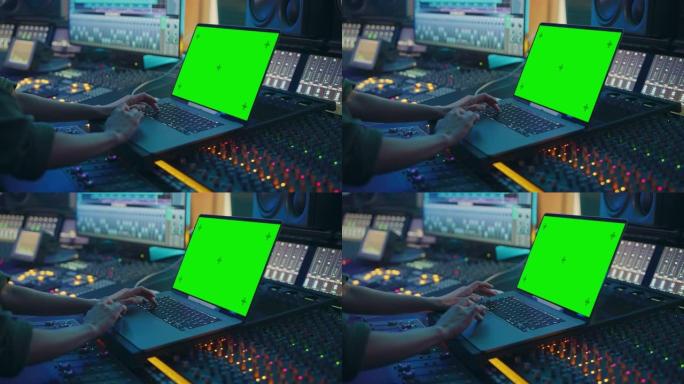 女艺术家，音乐家，制作人，音频工程师在音乐唱片工作室工作，制作新专辑，使用绿屏笔记本电脑，控制台进行