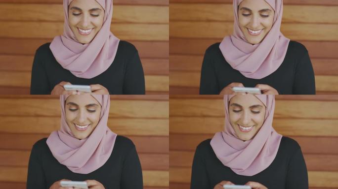 快乐的穆斯林妇女发短信