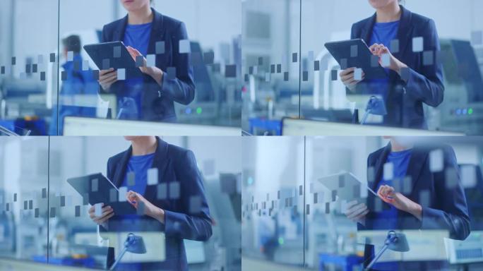 现代工厂办公室: 年轻自信的女性工业工程师站着拿着数字平板电脑，用手势高效工作。专注于手和平板电脑。
