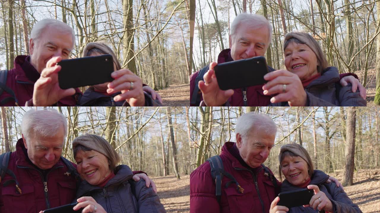 微笑的老年人用智能手机自拍