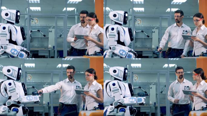 男人和女人检查机器人的工作。