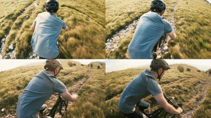 在阳光明媚的日子里，山地自行车骑手在落基山景观上下坡
