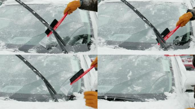 冬季大雪后，男子从汽车上除雪