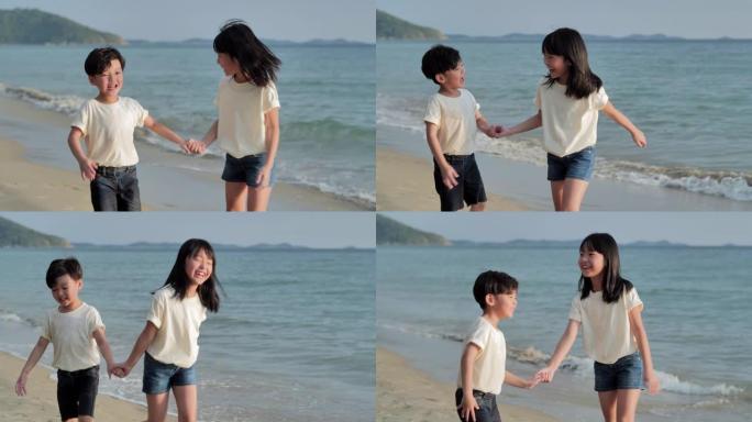快乐的亚洲男孩和女孩，在沙滩上沿着日落海上冲浪的边缘充满乐趣。儿童，快乐的家庭假期，家庭，生活方式，