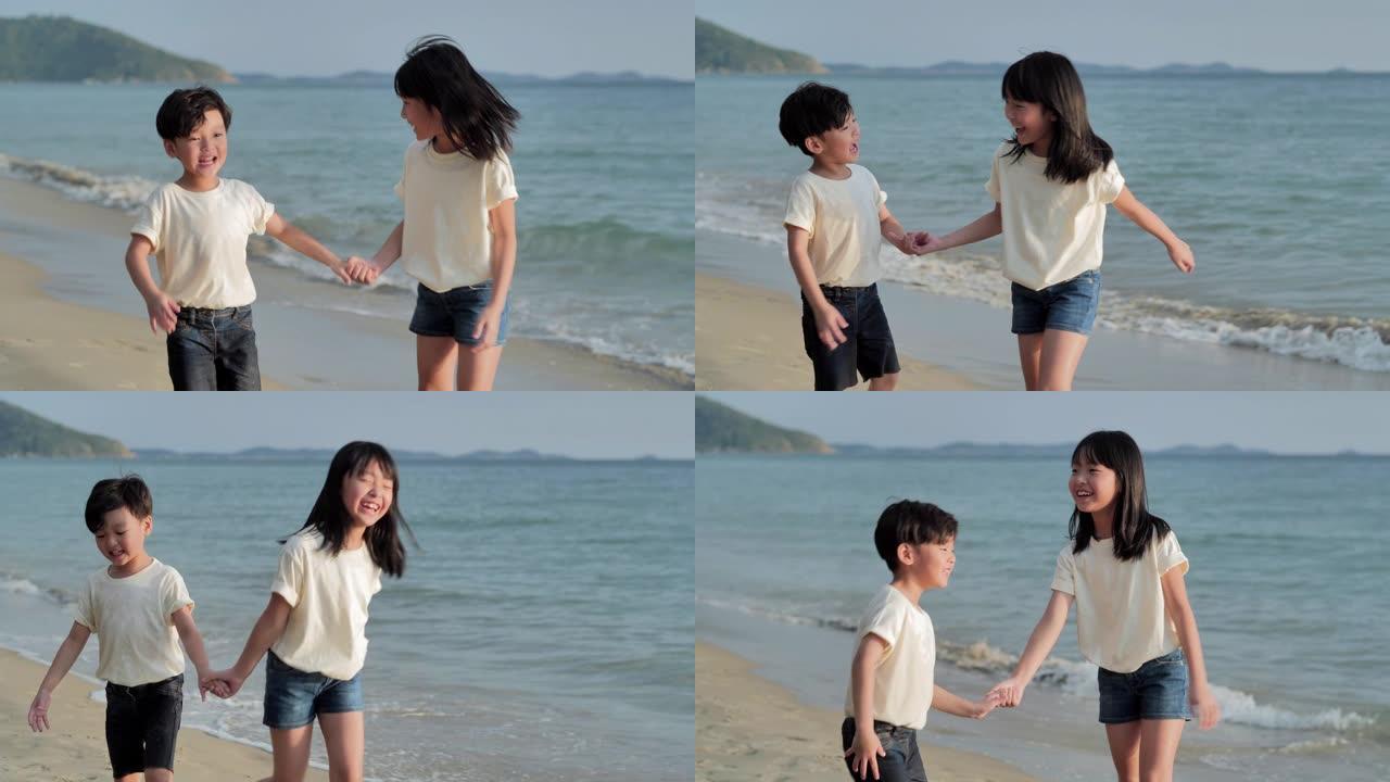 快乐的亚洲男孩和女孩，在沙滩上沿着日落海上冲浪的边缘充满乐趣。儿童，快乐的家庭假期，家庭，生活方式，