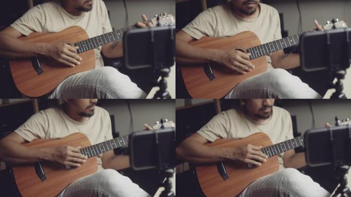 时髦的男人在网上用家里的视频教程上吉他课。