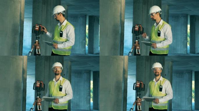 建造者，建筑师在建筑工地上使用激光水平仪。