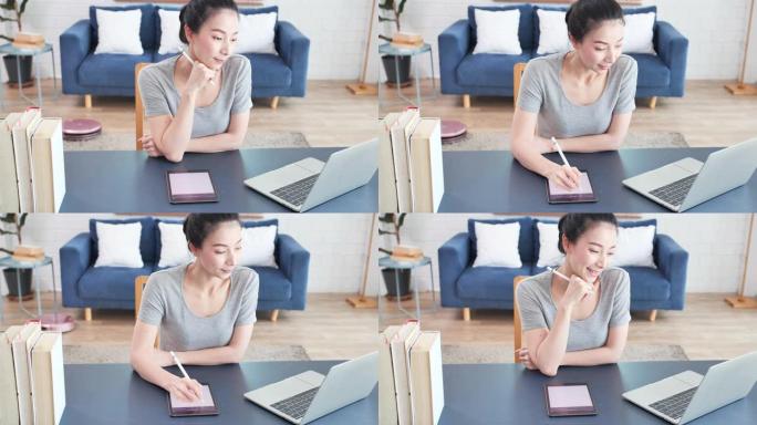 亚洲年轻女子使用数字平板电脑在家在线学习。新的家庭办公室设置
