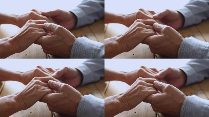 浪漫的中年已婚夫妇抚摸双手。