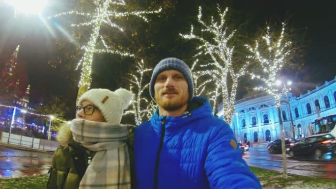 MS夫妇在奥地利维也纳的夜晚在照明的冬季城市中行走