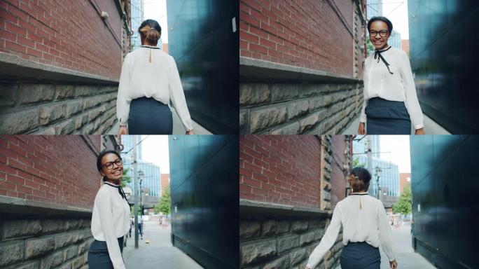 优雅的非洲裔美国女士走路的慢动作，然后转向相机
