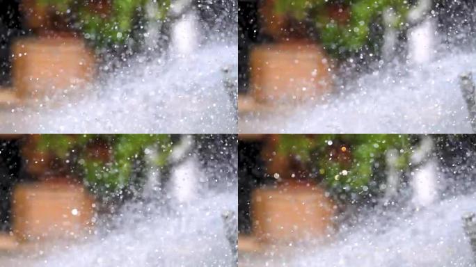 装饰喷泉以慢动作特写洒水，水颗粒向不同方向散射
