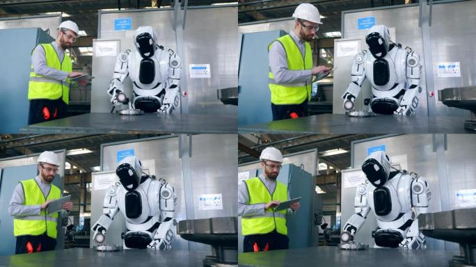 一个人在平板电脑上打字，而机器人则使用工厂细节。