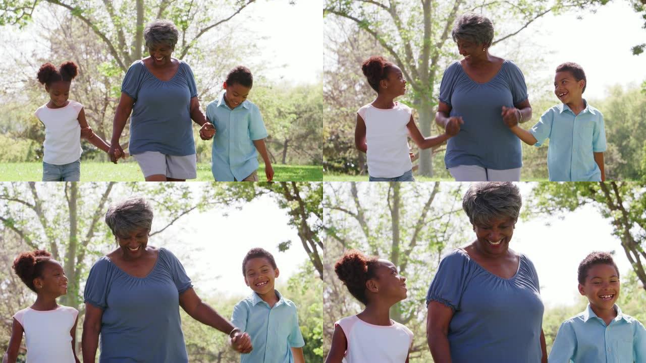 祖母在公园散步，与孙子孙女牵手