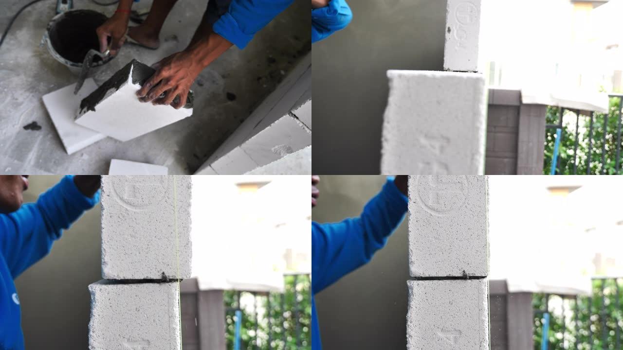 施工人员检查新建墙体的均匀度