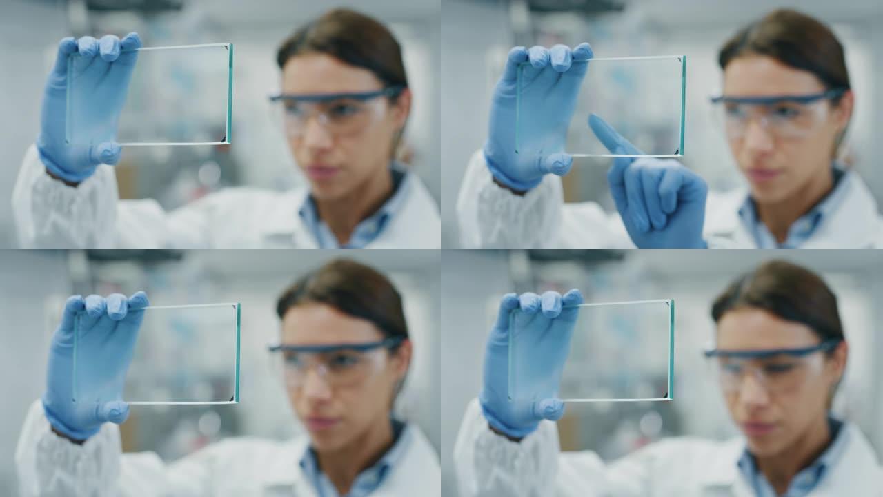未来主义研究人员的肖像使用带有全息图图形的增强现实屏幕来查看他在实验室中的研究结果。