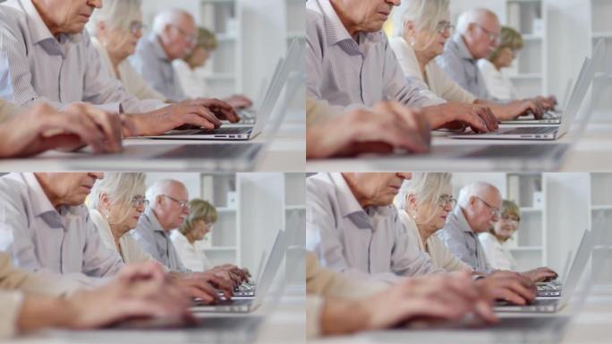 老年人在笔记本电脑上打字