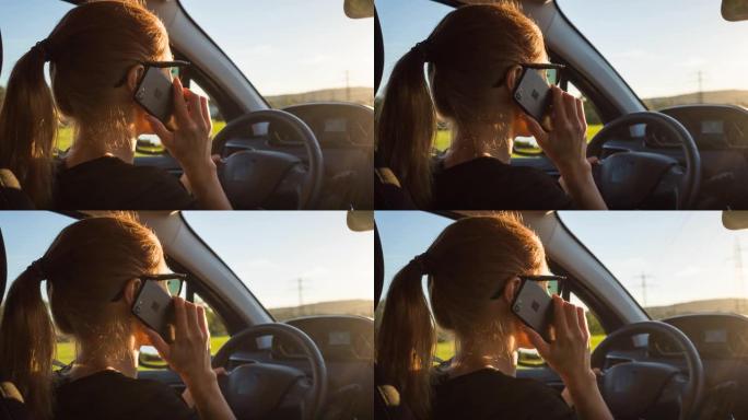 女人同时开车和手机通话