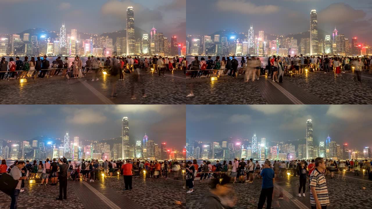 香港-2018年4月28日: 游客拍照，欣赏维多利亚港对面著名的香港岛天际线。时间流逝。