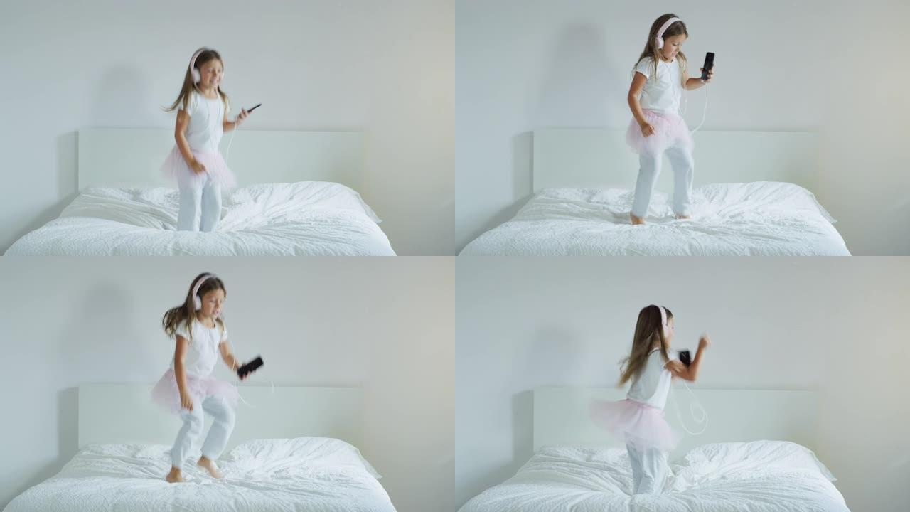 一个小女孩戴着耳机听音乐，在父母的床上跳舞的肖像。