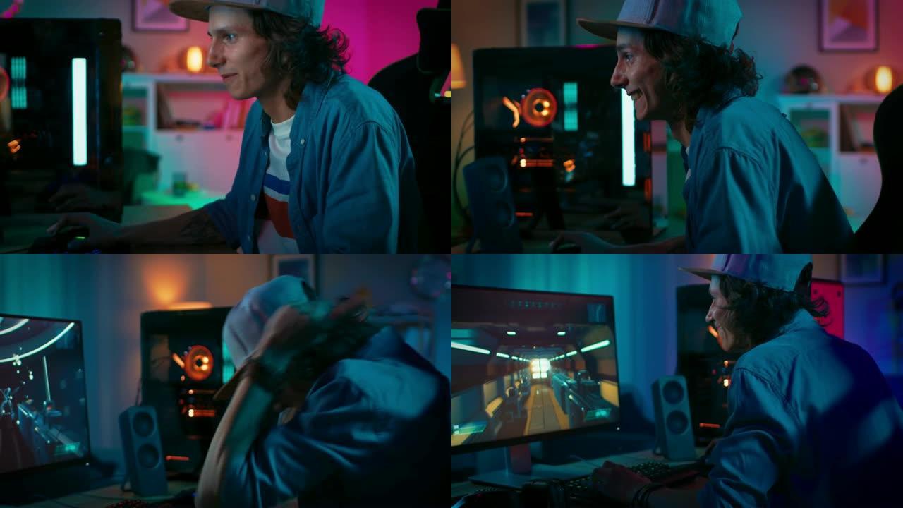 兴奋的玩家在他的个人电脑上玩并赢得第一人称射击游戏在线视频游戏。房间和电脑有彩色霓虹灯。年轻人戴着帽