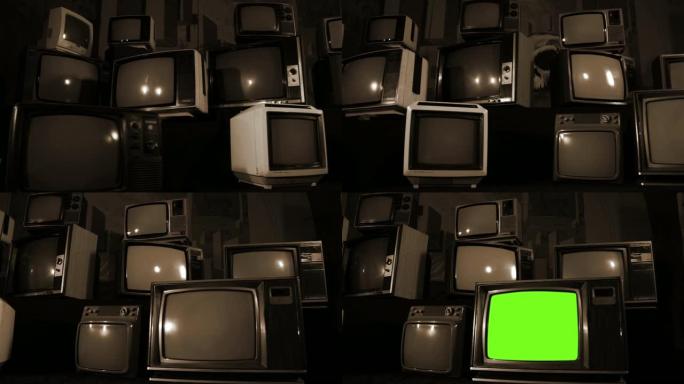 复古电视在许多电视中间打开绿色屏幕。棕褐色色调。