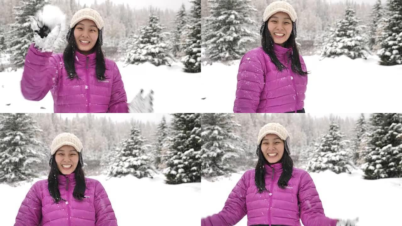 亚洲女人在相机里扔雪球