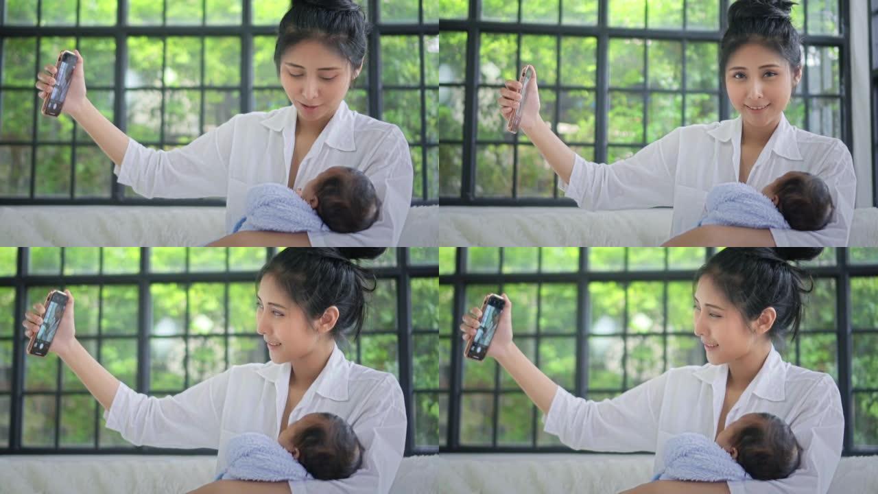 母亲和婴儿用智能手机自拍，慢动作