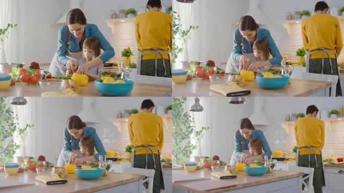 在厨房: 母亲和可爱的小女儿一起烹饪健康的晚餐。妈妈教小女孩健康的习惯，以及如何切蔬菜做沙拉。可爱的