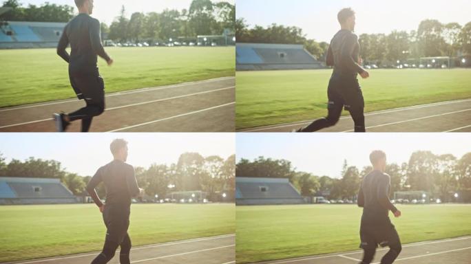 穿着灰色衬衫和短裤的运动健美男子在体育场慢跑。在一个温暖的夏日下午，他正在舒适地跑步。运动员做他的常