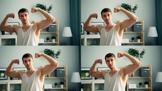英俊健美运动员的慢动作肖像，在家中举起肌肉发达的手臂