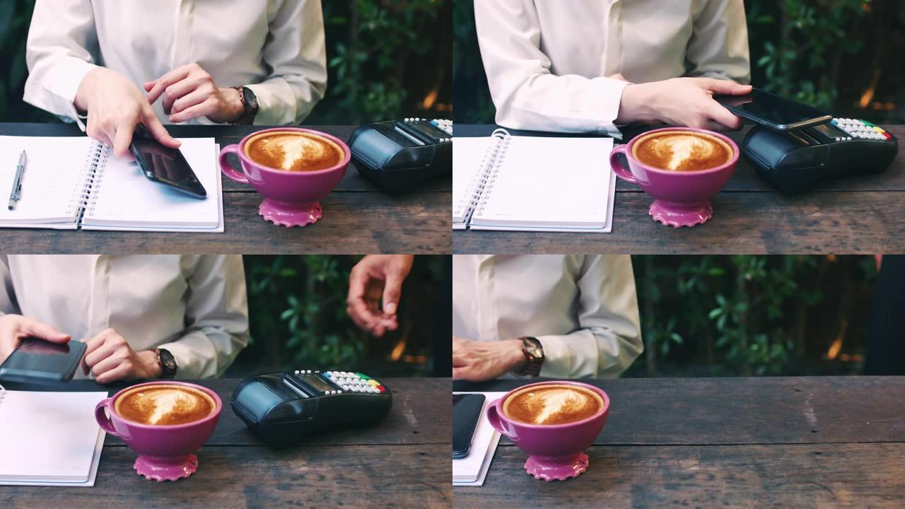 女人在咖啡馆中使用NFC技术通过智能手机付款