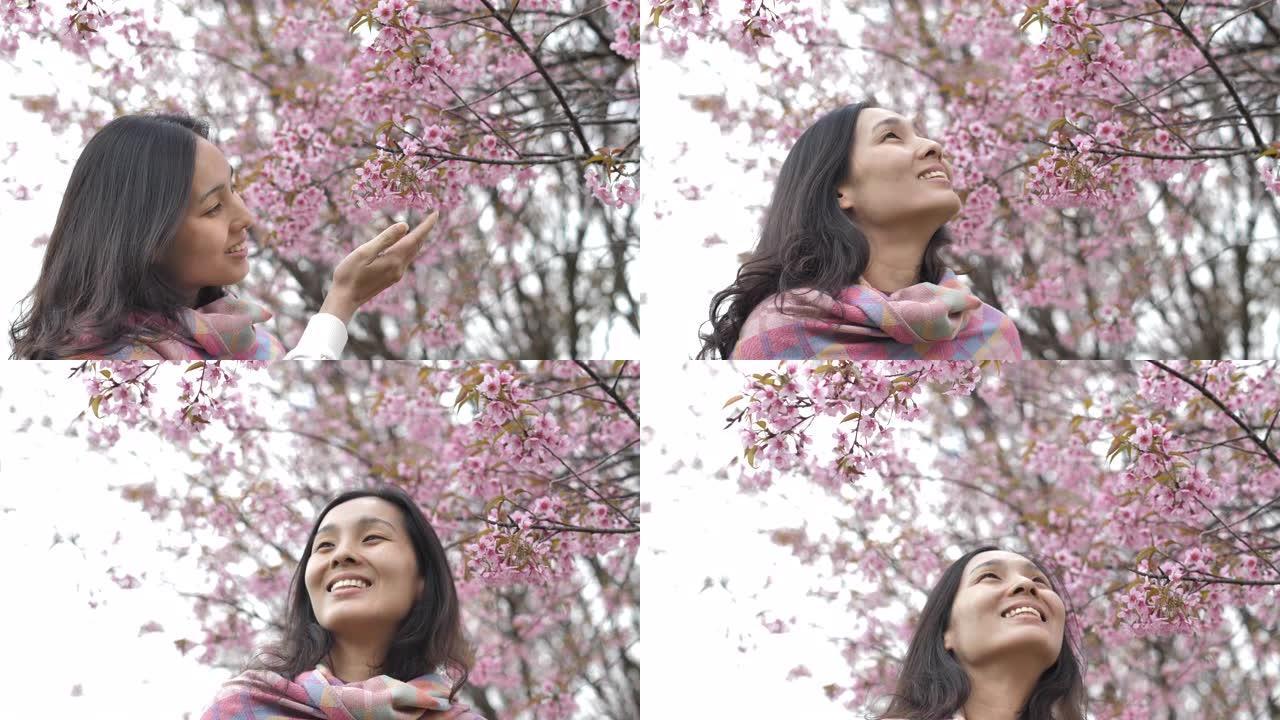 一个美丽的亚洲人在樱花的肖像