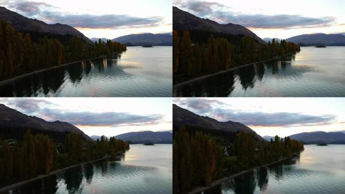 视频剪辑无人机在美丽的湖上飞行，飞到前面有脸部的反射，在雪山的前面是放松自然旅行的概念