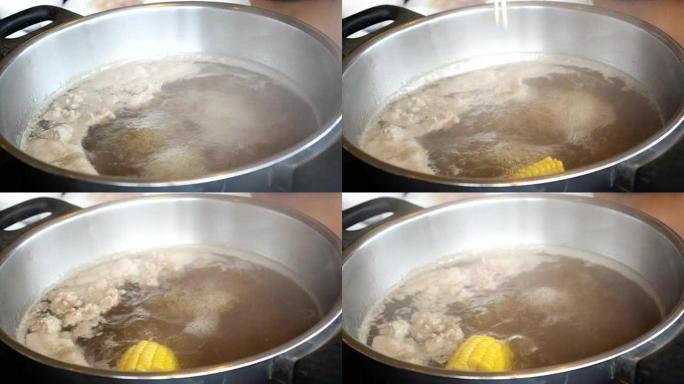 4k镜头煮汤火锅用筷子、沙锅、寿喜烧搅拌加玉米日式美食概念