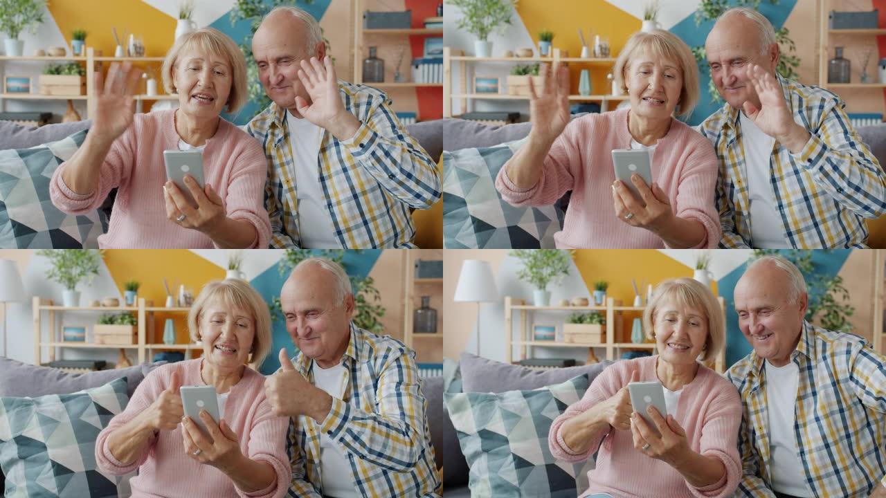 老年人进行在线视频通话，显示竖起大拇指的智能手机
