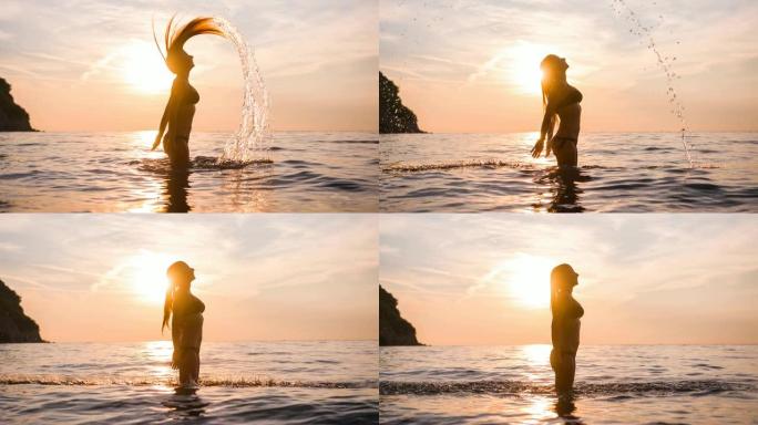 暑假穿着比基尼的女人站在海水中，用长长的湿头发和泼水做头发翻转