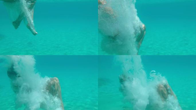 MS超级慢动作女人在碧蓝的海洋中水下潜水