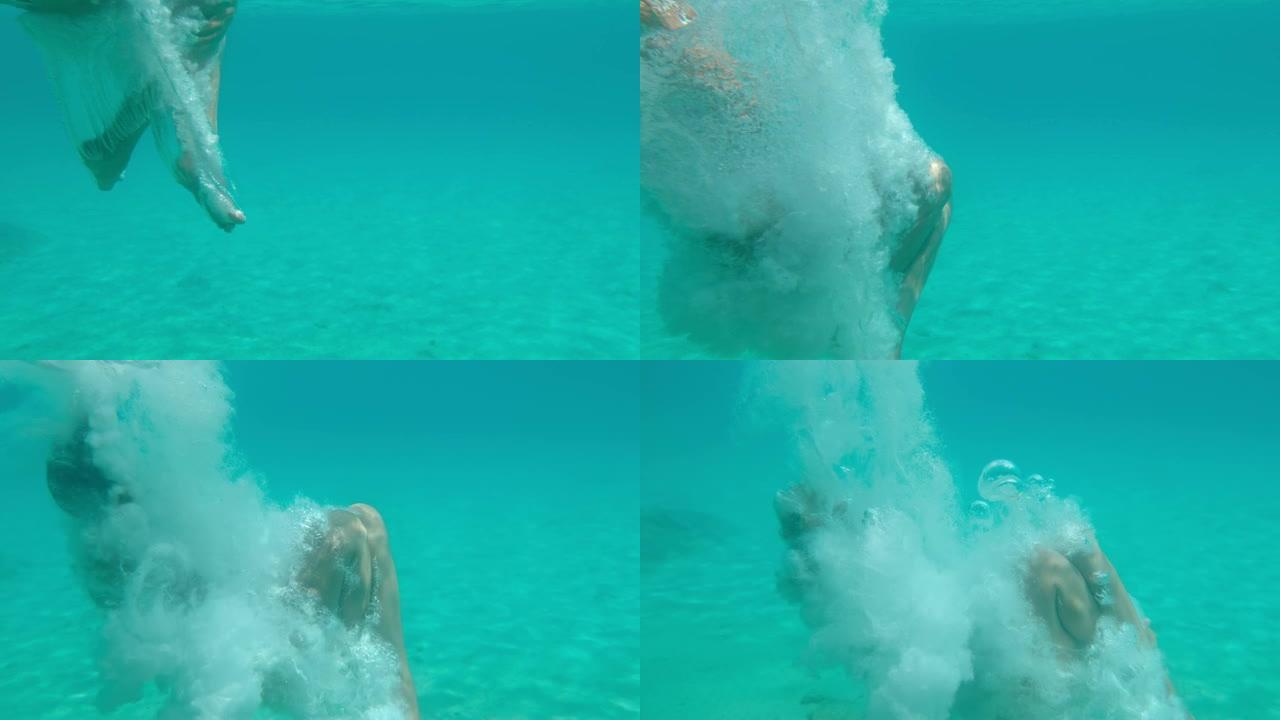 MS超级慢动作女人在碧蓝的海洋中水下潜水