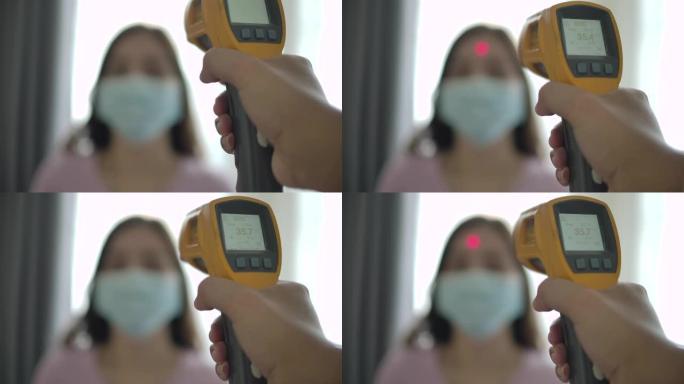 病人亚洲妇女面部和医生用体温计检查温度