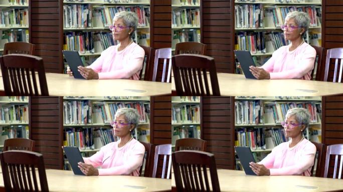 高级非裔美国妇女在图书馆读书