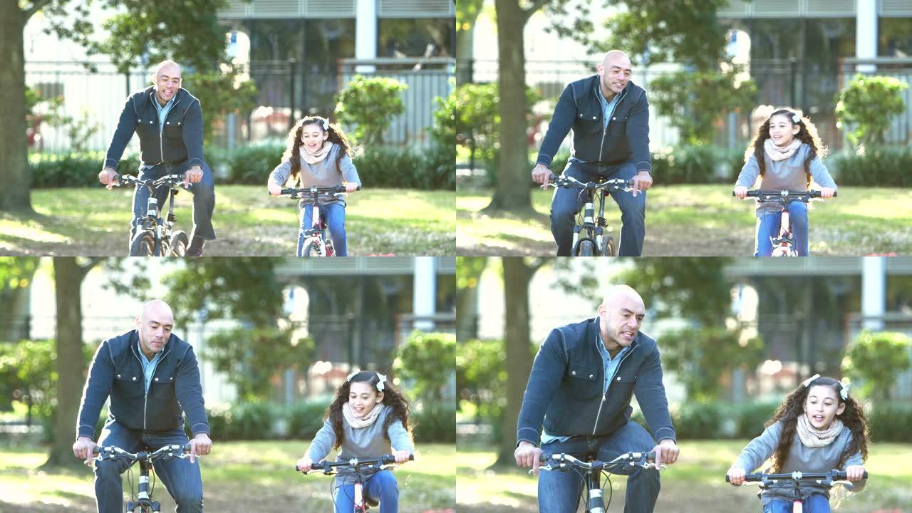 西班牙裔父亲和女儿在公园骑自行车