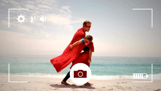 在数码相机上拍摄父女在海边的照片