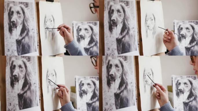 坐在画架上的艺术家的特写照片中的木炭狗的照片
